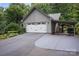 Side view of the two-car garage with gray siding and a covered carport at 140 Quiet Cove Rd, Mooresville, NC 28117