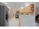 Well-lit kitchen with stainless steel appliances, tiled floors, wooden cabinetry, and adjacent dining area at 140 Quiet Cove Rd, Mooresville, NC 28117