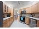 Bright kitchen with stainless appliances, light wood cabinets, tile backsplash, and open doorway at 140 Quiet Cove Rd, Mooresville, NC 28117