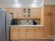 Kitchen with light wood cabinets, stainless steel appliances and ample counter space at 140 Quiet Cove Rd, Mooresville, NC 28117