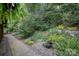 Beautifully landscaped yard with lush greenery, stone accents, and a serene water feature at 140 Quiet Cove Rd, Mooresville, NC 28117