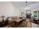 Cozy living room with a fireplace, leather sofa, and neutral carpet at 140 Quiet Cove Rd, Mooresville, NC 28117