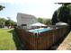 Backyard view of a pool surrounded by wood fence and lush greenery, providing privacy at 148 W Walnut Ave, Mount Holly, NC 28120