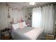Bedroom featuring geometric wallpaper and a grey bedspread at 148 W Walnut Ave, Mount Holly, NC 28120