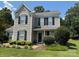 Charming two-story home with gray siding, black shutters and well-maintained landscaping at 148 W Walnut Ave, Mount Holly, NC 28120