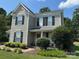 Charming two-story home with gray siding, black shutters and well-maintained landscaping at 148 W Walnut Ave, Mount Holly, NC 28120