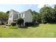 Charming home exterior with a spacious yard, perfect for outdoor activities at 148 W Walnut Ave, Mount Holly, NC 28120