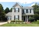 Charming two-story home with gray siding, black shutters and well-maintained landscaping at 148 W Walnut Ave, Mount Holly, NC 28120