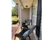 Cozy front porch featuring two dark wicker chairs with blue pillows, next to the home's window at 148 W Walnut Ave, Mount Holly, NC 28120