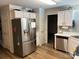 Modern kitchen featuring stainless steel appliances, white cabinetry, and wood-look flooring at 148 W Walnut Ave, Mount Holly, NC 28120