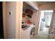 Laundry room featuring washer, dryer and shelving for storage at 148 W Walnut Ave, Mount Holly, NC 28120