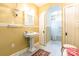 Well-lit bathroom with classic pedestal sink and adjacent shower and toilet room at 15 Kings Mountain St, York, SC 29745