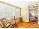 Sunroom with wood floors and plenty of natural light leading into bedroom at 15 Kings Mountain St, York, SC 29745
