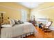 Bedroom with wooden floors, natural light, a fireplace, and a rocking chair at 15 Kings Mountain St, York, SC 29745