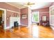 Bedroom with fireplace, hardwood floors, large windows, and classic decor at 15 Kings Mountain St, York, SC 29745