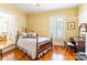 Bedroom with wooden floors, natural light, and a door leading into another living space at 15 Kings Mountain St, York, SC 29745