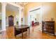 Spacious entryway with gleaming hardwood floors, classic columns, and a view into the living room at 15 Kings Mountain St, York, SC 29745