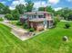 Green lawn surrounds a brick two-story with screened in porch and outdoor seating area at 15 Kings Mountain St, York, SC 29745