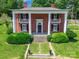 Elegant two-story brick home featuring stately columns, a covered porch, and well-manicured landscaping at 15 Kings Mountain St, York, SC 29745