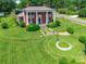 Charming brick home featuring white columns, manicured lawn, and beautiful garden details at 15 Kings Mountain St, York, SC 29745