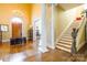 Bright foyer featuring a wooden staircase, decorative columns, hardwood floors, and chandelier at 15 Kings Mountain St, York, SC 29745