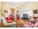 Bright living room with fireplace, wood floors, chandelier, and comfortable seating at 15 Kings Mountain St, York, SC 29745