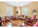 Bright living room with hardwood floors, classic furniture, and ample natural light from large windows at 15 Kings Mountain St, York, SC 29745