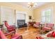 Cozy living room with a decorative fireplace, large windows, and classic furnishings at 15 Kings Mountain St, York, SC 29745