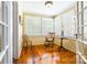 Bright sunroom featuring a rocking chair, side table, wood floors, and ample windows at 15 Kings Mountain St, York, SC 29745