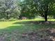 Expansive backyard with mature trees, lush greenery, and potential for outdoor activities at 1909 Normandy Rd, Kannapolis, NC 28081