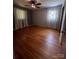Spacious bedroom with hardwood floors and two windows draped with curtains at 1909 Normandy Rd, Kannapolis, NC 28081