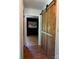 Hallway featuring wood floors and a large sliding barn door at 1909 Normandy Rd, Kannapolis, NC 28081
