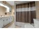 Well-lit bathroom featuring a shower with a decorative privacy curtain at 1920 E Nc Hwy 24/27 None, Biscoe, NC 27209