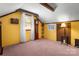 Quaint bedroom with a sloped ceiling, neutral carpet, and a built-in storage cabinet at 1920 E Nc Hwy 24/27 None, Biscoe, NC 27209
