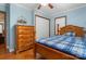 Bedroom featuring light blue walls, a wooden bed, and a closet at 1920 E Nc Hwy 24/27 None, Biscoe, NC 27209