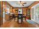 Charming dining room with wood paneling, a ceiling fan, and a view to the kitchen and backyard at 1920 E Nc Hwy 24/27 None, Biscoe, NC 27209