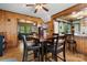 Cozy dining room adjacent to kitchen, wood paneling, and view of the living room with wood floors at 1920 E Nc Hwy 24/27 None, Biscoe, NC 27209