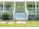 Charming covered front porch with white railings, steps, and stepping stones to the yard at 1920 E Nc Hwy 24/27 None, Biscoe, NC 27209