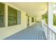 Inviting covered porch with a painted blue floor, hanging plants, and ample space for relaxing at 1920 E Nc Hwy 24/27 None, Biscoe, NC 27209