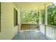 Covered porch featuring a cozy wooden swing, offering a relaxing outdoor space at 1920 E Nc Hwy 24/27 None, Biscoe, NC 27209