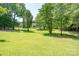 Expansive front yard with mature trees offering shade and curb appeal at 1920 E Nc Hwy 24/27 None, Biscoe, NC 27209