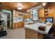Quaint kitchen featuring wood-paneled ceilings, white countertops, and classic appliances at 1920 E Nc Hwy 24/27 None, Biscoe, NC 27209