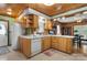 Bright kitchen showcasing wood cabinets, a white refrigerator, and an open view to dining area at 1920 E Nc Hwy 24/27 None, Biscoe, NC 27209
