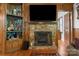 Living room showcasing a stone fireplace with a mounted TV and built-in shelving at 1920 E Nc Hwy 24/27 None, Biscoe, NC 27209