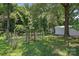 Scenic backyard with multiple storage buildings and wooded backdrop at 207 W 21St St, Kannapolis, NC 28081