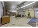 Unfinished basement with ample workspace, shelving and garage door, great for projects and hobbies at 207 W 21St St, Kannapolis, NC 28081