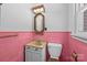 Vintage pink bathroom with unique wall tiles, a new toilet, and well-maintained retro fixtures at 207 W 21St St, Kannapolis, NC 28081