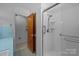 Bathroom featuring blue tile, vanity, walk-in shower, and a door to a separate room at 207 W 21St St, Kannapolis, NC 28081