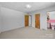 Bright bedroom with connecting bathroom featuring two windows, carpeted floors and white walls for a calm space at 207 W 21St St, Kannapolis, NC 28081
