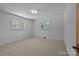 Bright bedroom featuring two windows, carpeted floors and white walls for a calm, neutral space at 207 W 21St St, Kannapolis, NC 28081